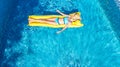 Beautiful young girl relaxing in swimming pool, woman swims on inflatable mattress and has fun in water on family vacation Royalty Free Stock Photo