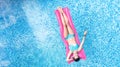 Beautiful young girl relaxing in swimming pool, woman swims on inflatable mattress and has fun in water on family vacation Royalty Free Stock Photo