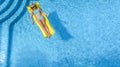 Beautiful young girl relaxing in swimming pool, woman swims on inflatable mattress and has fun in water on family vacation Royalty Free Stock Photo