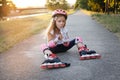 Beautiful young girl resting after ride on roller skates in the park Royalty Free Stock Photo