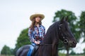 Beautiful young girl riding a horse in countryside Royalty Free Stock Photo