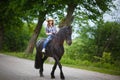 Beautiful young girl riding a horse in countryside Royalty Free Stock Photo