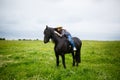 Beautiful young girl riding a horse in countryside Royalty Free Stock Photo