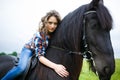 Beautiful young girl riding a horse in countryside Royalty Free Stock Photo