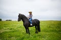 Beautiful young girl riding a horse in countryside Royalty Free Stock Photo