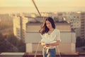 Beautiful young girl at the roof with origami paper crane in hands Royalty Free Stock Photo