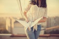 Beautiful young girl at the roof with origami paper crane in hands Royalty Free Stock Photo