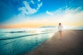 Beautiful young girl running and playing side sea on sand. Royalty Free Stock Photo