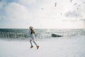 beautiful young girl running on winter quay