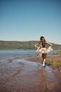 Beautiful young girl runs along the beach Royalty Free Stock Photo