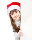 Beautiful young girl with santa hat standing behind white board. isolated Royalty Free Stock Photo