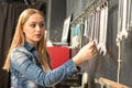 Beautiful young girl searching for a wrench and tool for bike repairs