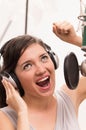 Beautiful young girl singing in music studio Royalty Free Stock Photo