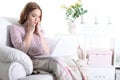 Beautiful young girl sitting in a chair with a laptop Royalty Free Stock Photo