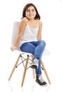 Beautiful young girl sitting on a chair Royalty Free Stock Photo