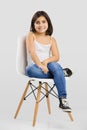 Beautiful young girl sitting on a chair Royalty Free Stock Photo