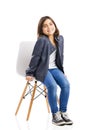 Beautiful young girl sitting on a chair Royalty Free Stock Photo