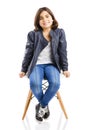 Beautiful young girl sitting on a chair Royalty Free Stock Photo