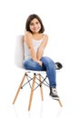 Beautiful young girl sitting on a chair Royalty Free Stock Photo