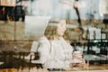 Beautiful young  girl sitting and enjoing coffee in restaurant Royalty Free Stock Photo