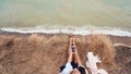 Beautiful young girl sitting and holding a smartphone in her hands, top view Royalty Free Stock Photo