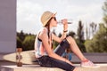 Beautiful young girl sitting on the roof and drinking water Royalty Free Stock Photo