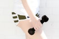 Beautiful young girl in sportwear holding two black dumbbells