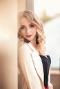 Beautiful young girl standing near the stone wall. Portrait pretty young fashion girl near a stone wall. Beautiful blonde woman Royalty Free Stock Photo