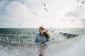 beautiful young girl standing on winter quay