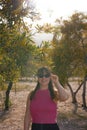 Beautiful young girl stands in the garden of mimosa trees blooming with yellow flowers Royalty Free Stock Photo