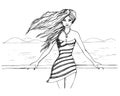 Beautiful young girl stands on the promenade and the wind develops her long hair. Summer vacation travel