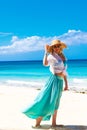 Beautiful young girl in a straw hat on a tropical beach Royalty Free Stock Photo