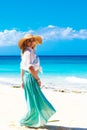 Beautiful young girl in a straw hat on a tropical beach Royalty Free Stock Photo