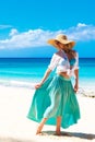 Beautiful young girl in a straw hat on a tropical beach Royalty Free Stock Photo