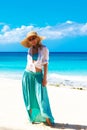 Beautiful young girl in a straw hat on a tropical beach Royalty Free Stock Photo