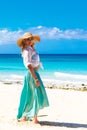 Beautiful young girl in a straw hat on a tropical beach Royalty Free Stock Photo