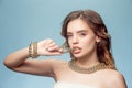 Beautiful young girl in studio with pearl jewelry - earrings, bracelet, necklace.