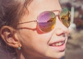 Beautiful young girl in sunglasses with beach reflection. Royalty Free Stock Photo