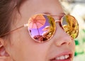 Beautiful young girl in sunglasses with beach umbrella reflection Royalty Free Stock Photo