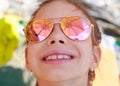 Beautiful young girl in sunglasses with beach umbrella reflection. Royalty Free Stock Photo