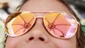 Beautiful young girl in sunglasses with beach umbrella rerlection. Royalty Free Stock Photo