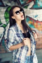 Beautiful young girl in sunglasses is going to swallow pills. Royalty Free Stock Photo