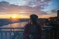 Beautiful young girl traveler standing at sunset overlooking the Royalty Free Stock Photo