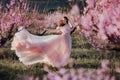 Beautiful young girl under the flowering pink tree Royalty Free Stock Photo