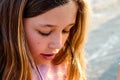 Beautiful young girl using her smartphone to call or send a message Royalty Free Stock Photo