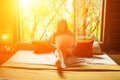 Beautiful young girl using a laptop in room on bed in jungle resort eco house Royalty Free Stock Photo