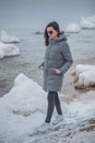 Beautiful young girl walking on the beach winter Royalty Free Stock Photo