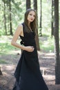 Beautiful young girl walking in a fairy forest. Royalty Free Stock Photo