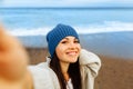 A beautiful young girl walks along the seashore, a storm, hair fly apart, a gray cardigan, a sports figure in sneakers Royalty Free Stock Photo