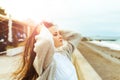 A beautiful young girl walks along the seashore, a storm, hair fly apart, a gray cardigan, a sports figure in sneakers Royalty Free Stock Photo